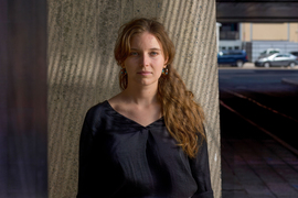 Dominika Ďurovčíková stands outside with MIT buildings in background.